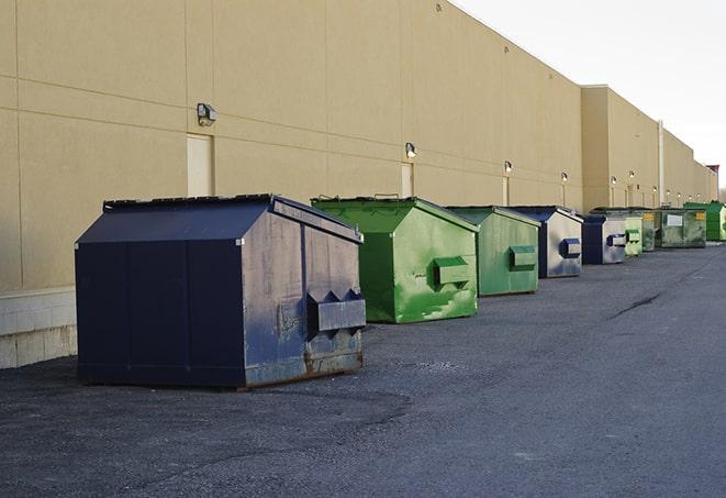 a pile of demolition waste sits beside a dumpster in a parking lot in Clearwater, FL